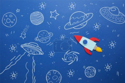 creative rocket on blue paper background with universe icons